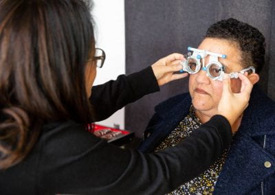 Female survey participant receives refraction by a female optometrist